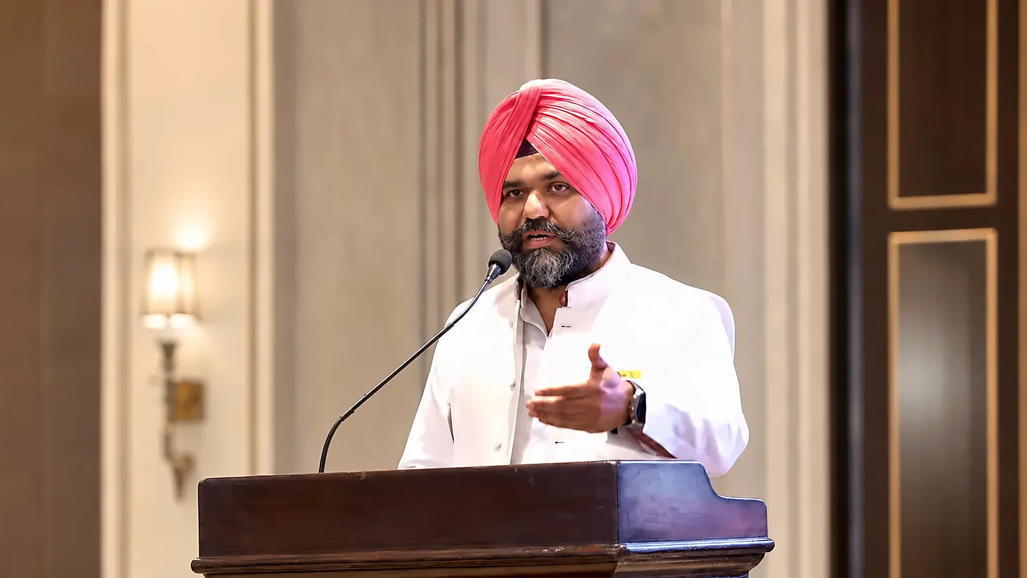 Hardeep Singh Saini speaking at a podium