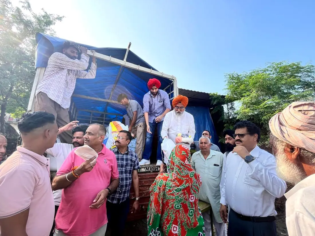 Relief supplies being handed down from a truck after the Punjab floods